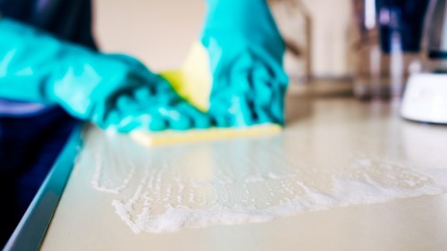 Local cleaner working in a Westhampstead apartment with shared building access